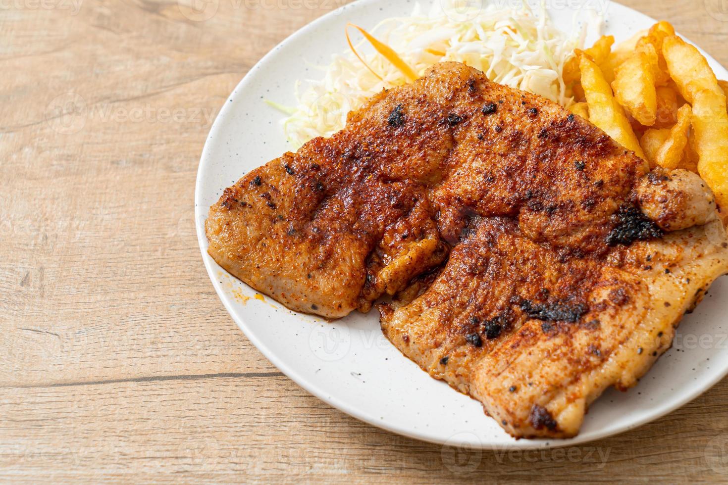 Grilled spicy barbecue kurobuta pork steak with french fries photo