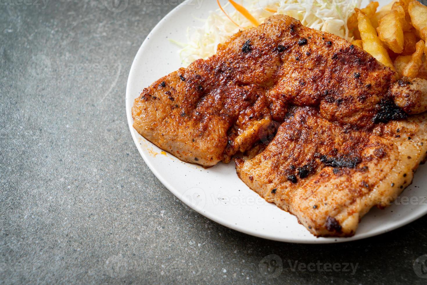 Grilled spicy barbecue kurobuta pork steak with french fries photo