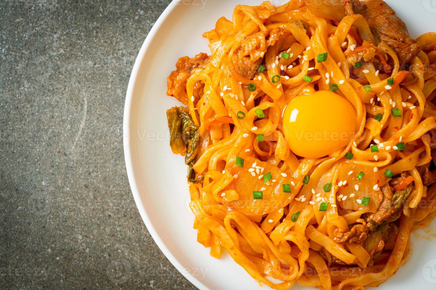 Stirfried udon noodles with kimchi and pork Korean food style