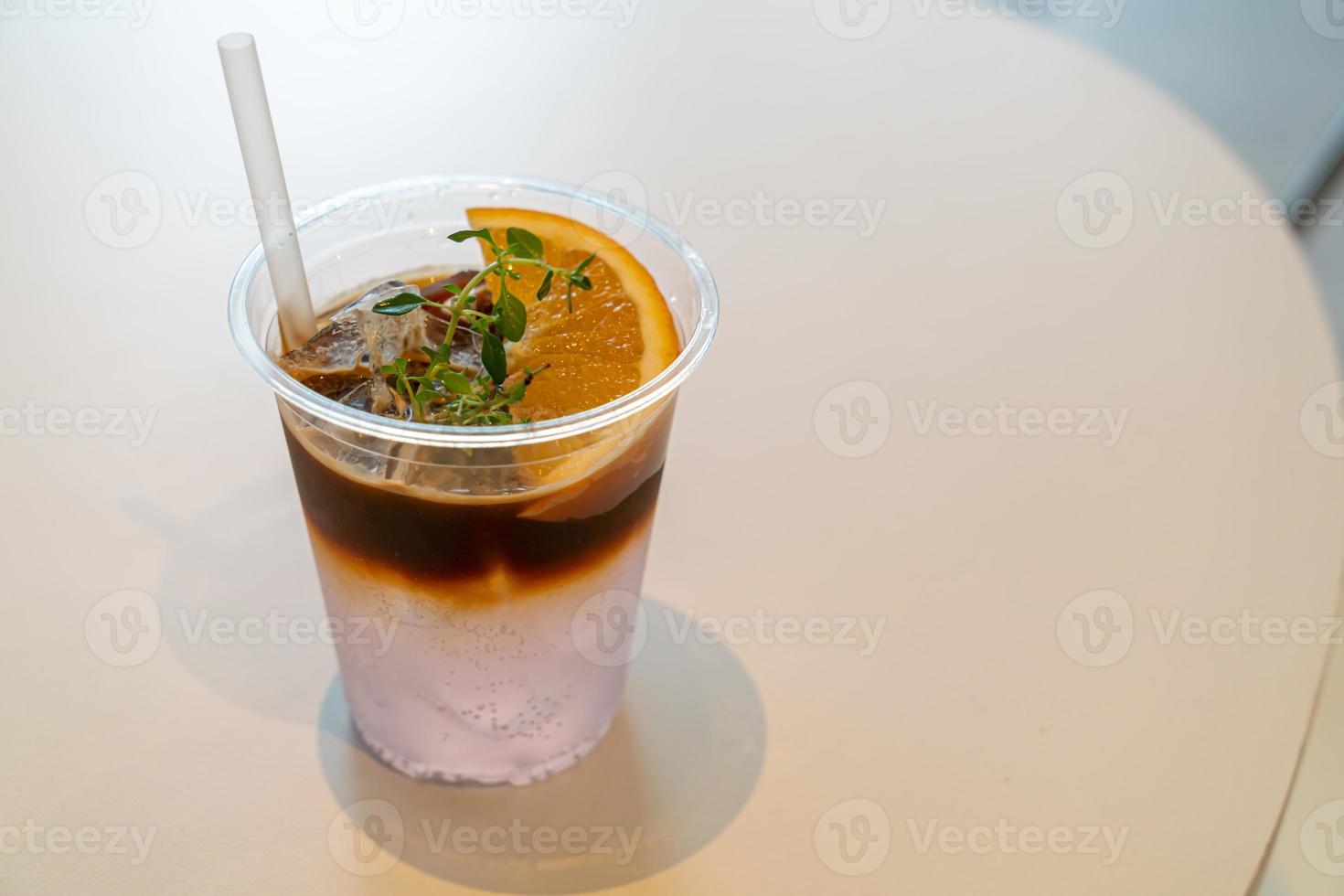 Espresso coffee tonic with yuzu orange in cafe restaurant photo