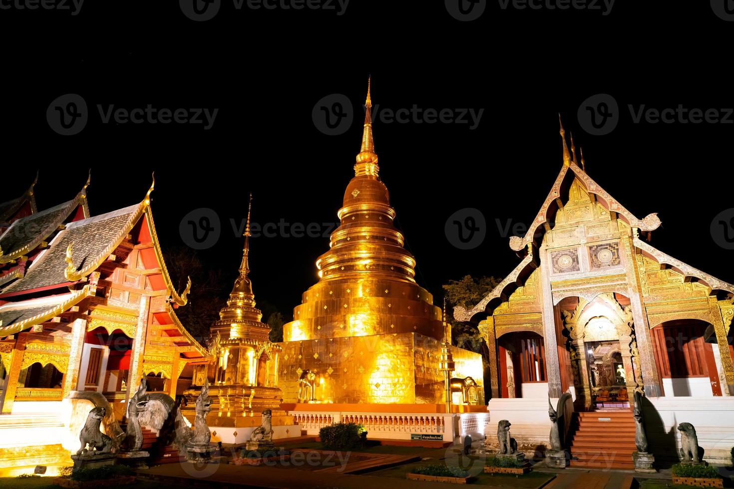 Beautiful architecture at Wat Phra Sing Waramahavihan temple at night in Chiang Mai province, Thailand photo