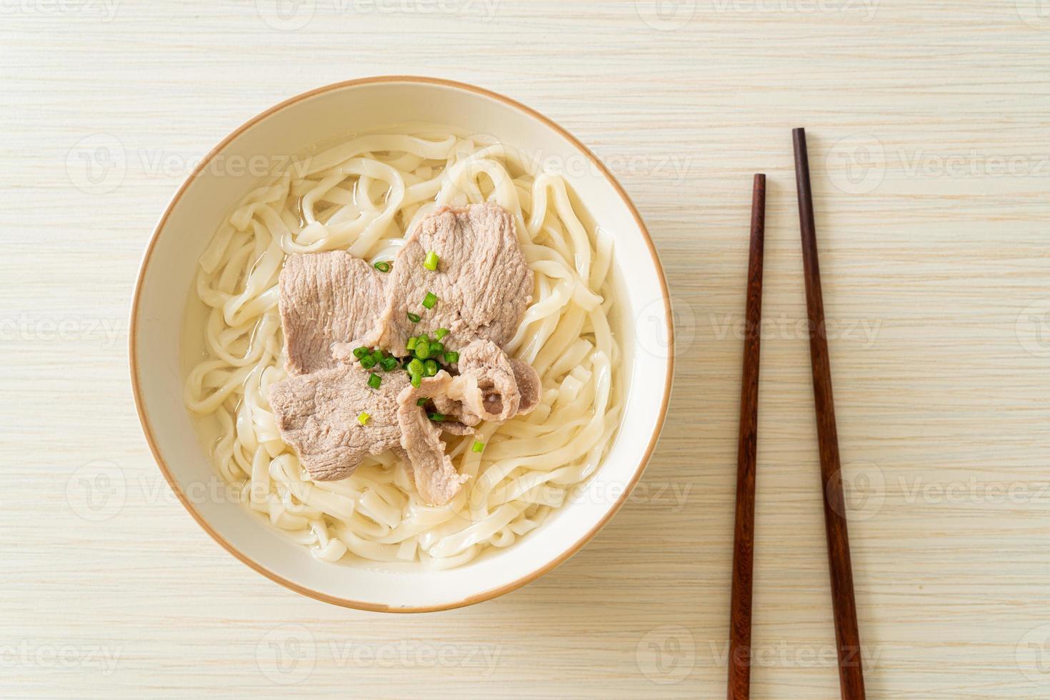 Homemade udon ramen noodles with pork in clear soup photo