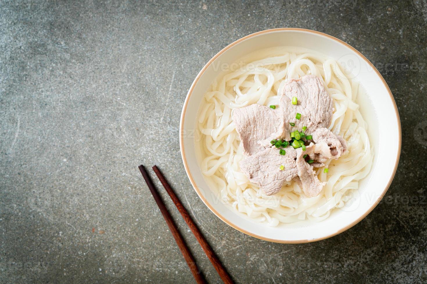 Homemade udon ramen noodles with pork in clear soup photo