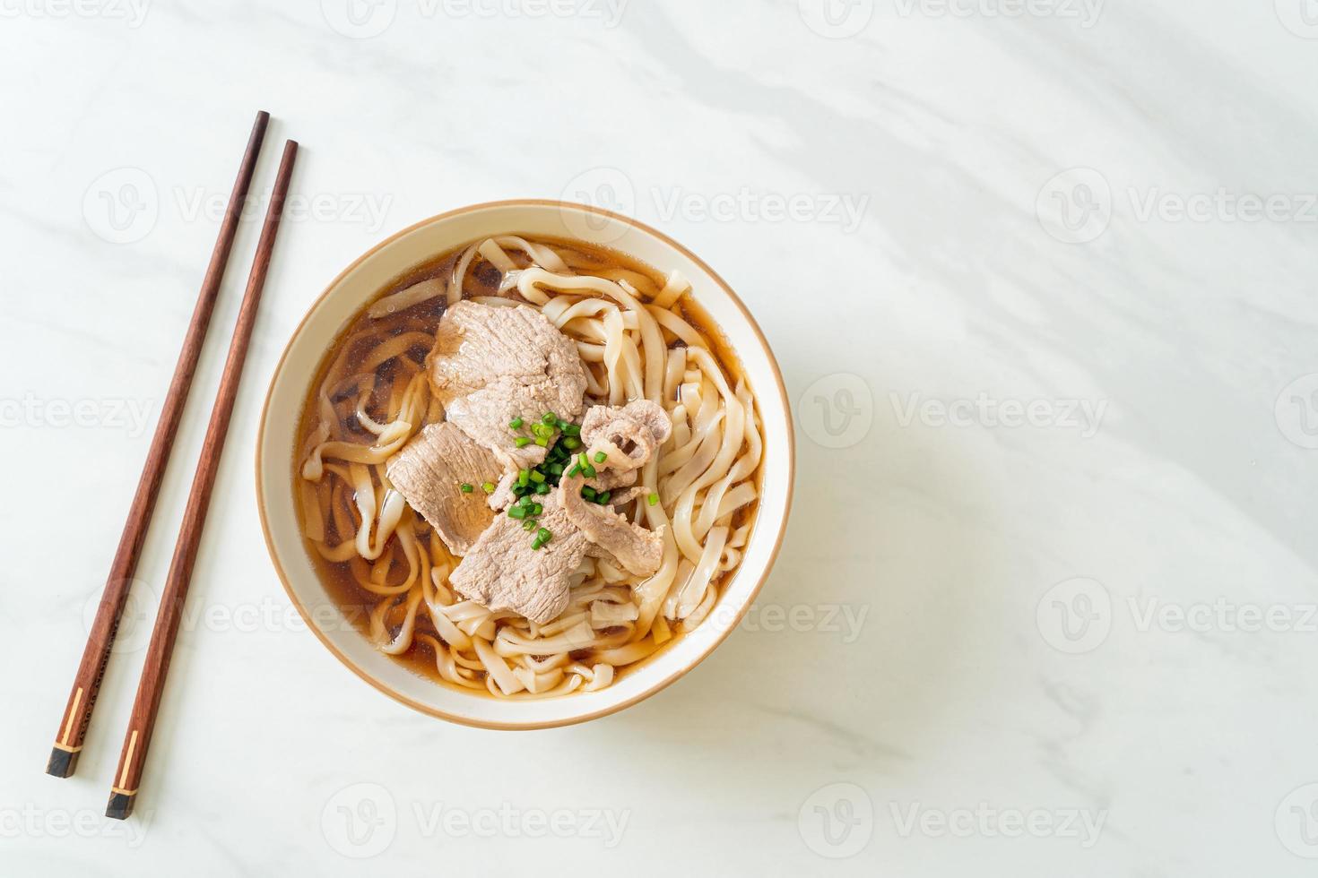 Homemade udon ramen noodles with pork in soy or shoyu soup photo