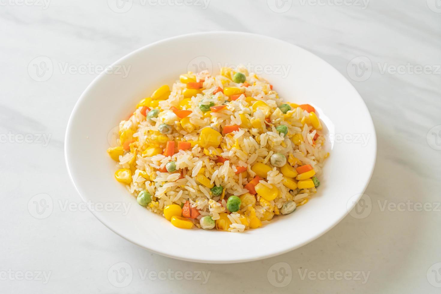 Homemade fried rice with mixed vegetables of carrot, green bean peas, corn, and egg photo