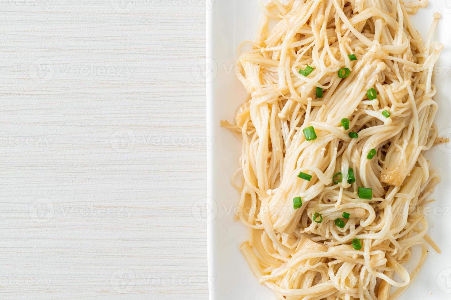 Stir-fried golden needle mushroom with butter on white plate photo