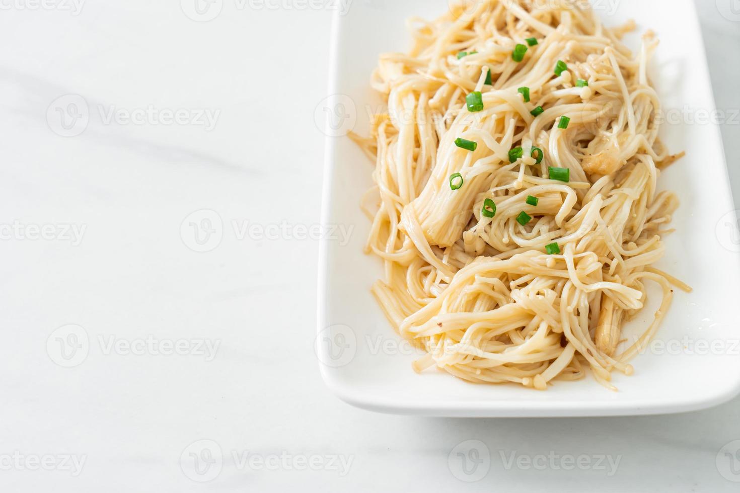 Stir-fried golden needle mushroom with butter on white plate photo
