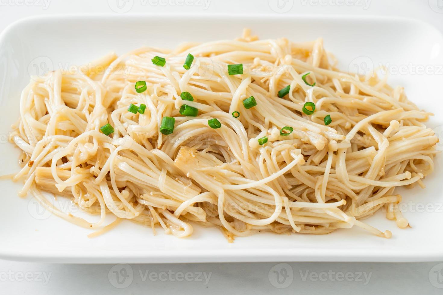 Stir-fried golden needle mushroom with butter on white plate photo