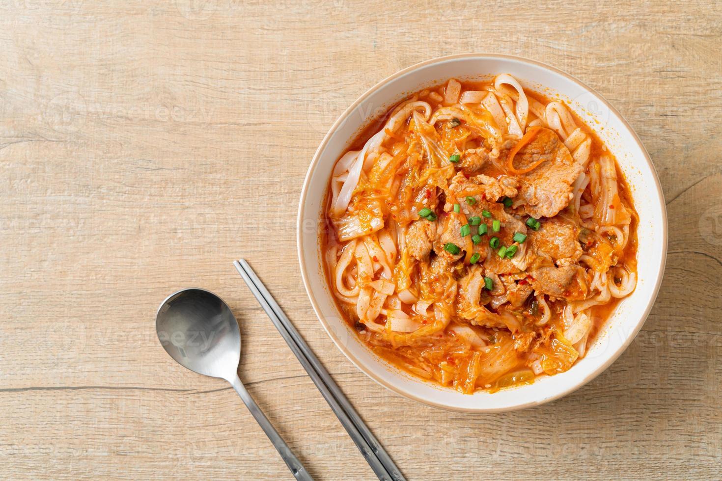 Korean udon ramen noodles with pork in kimchi soup photo