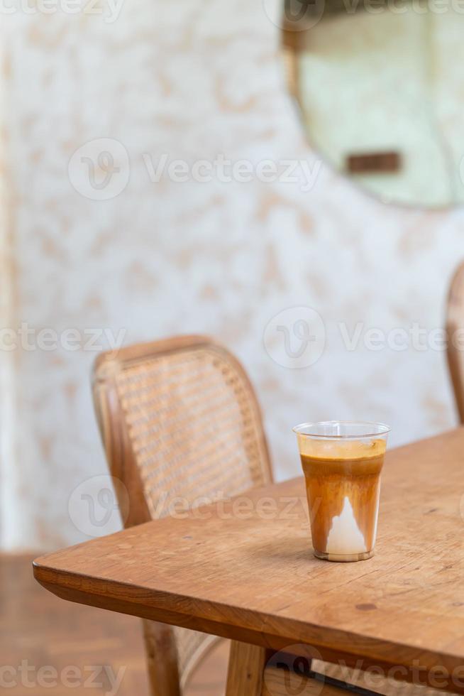 Specialty coffee menu called 'Dirty coffee' . Cold milk in the bottom with hot espresso shot on top photo