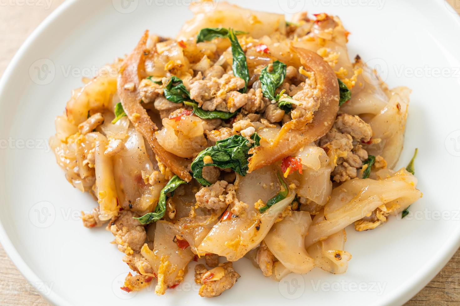 Stir-fried noodle with minced chicken and basil photo