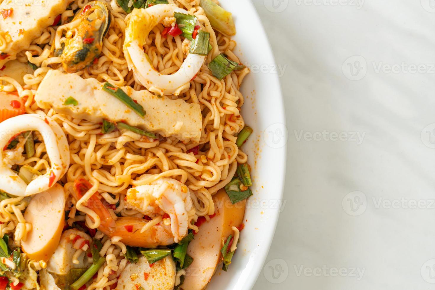 Instant noodle spicy salad with mixed meats photo