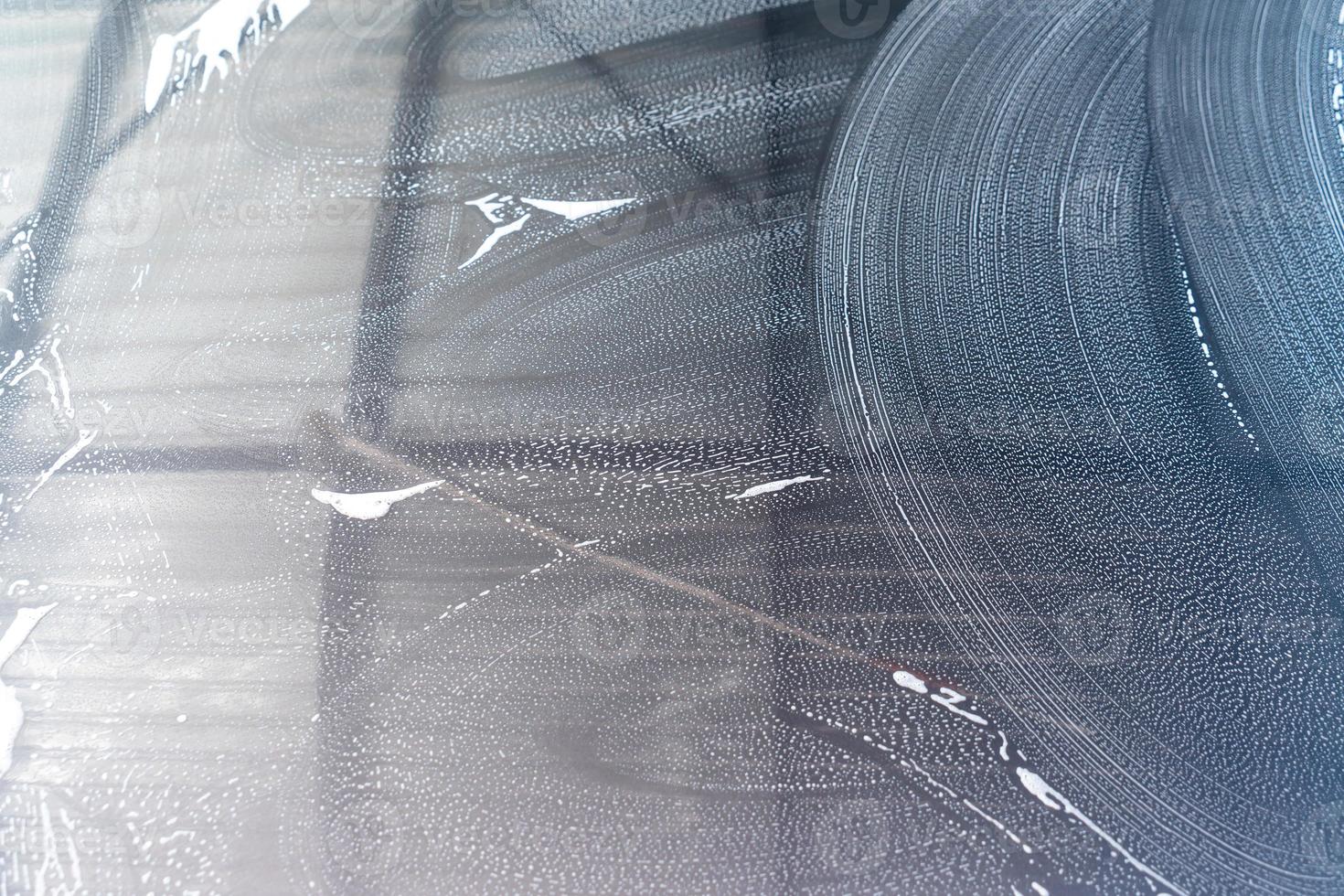 Close-up grey car with washing foam photo