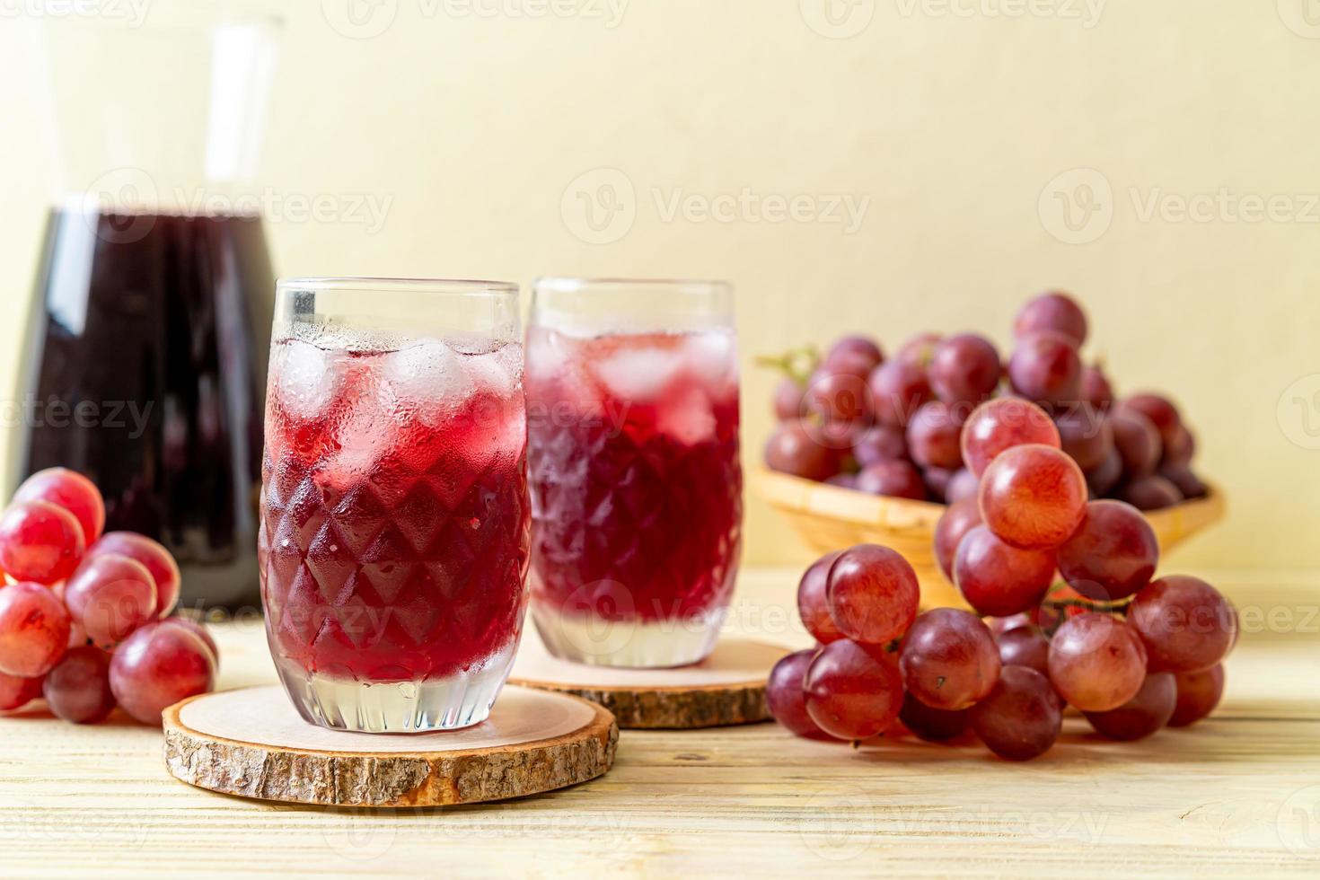 Fresh grape juice on wood background photo