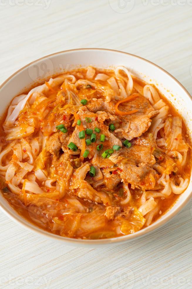 Korean udon ramen noodles with pork in kimchi soup photo