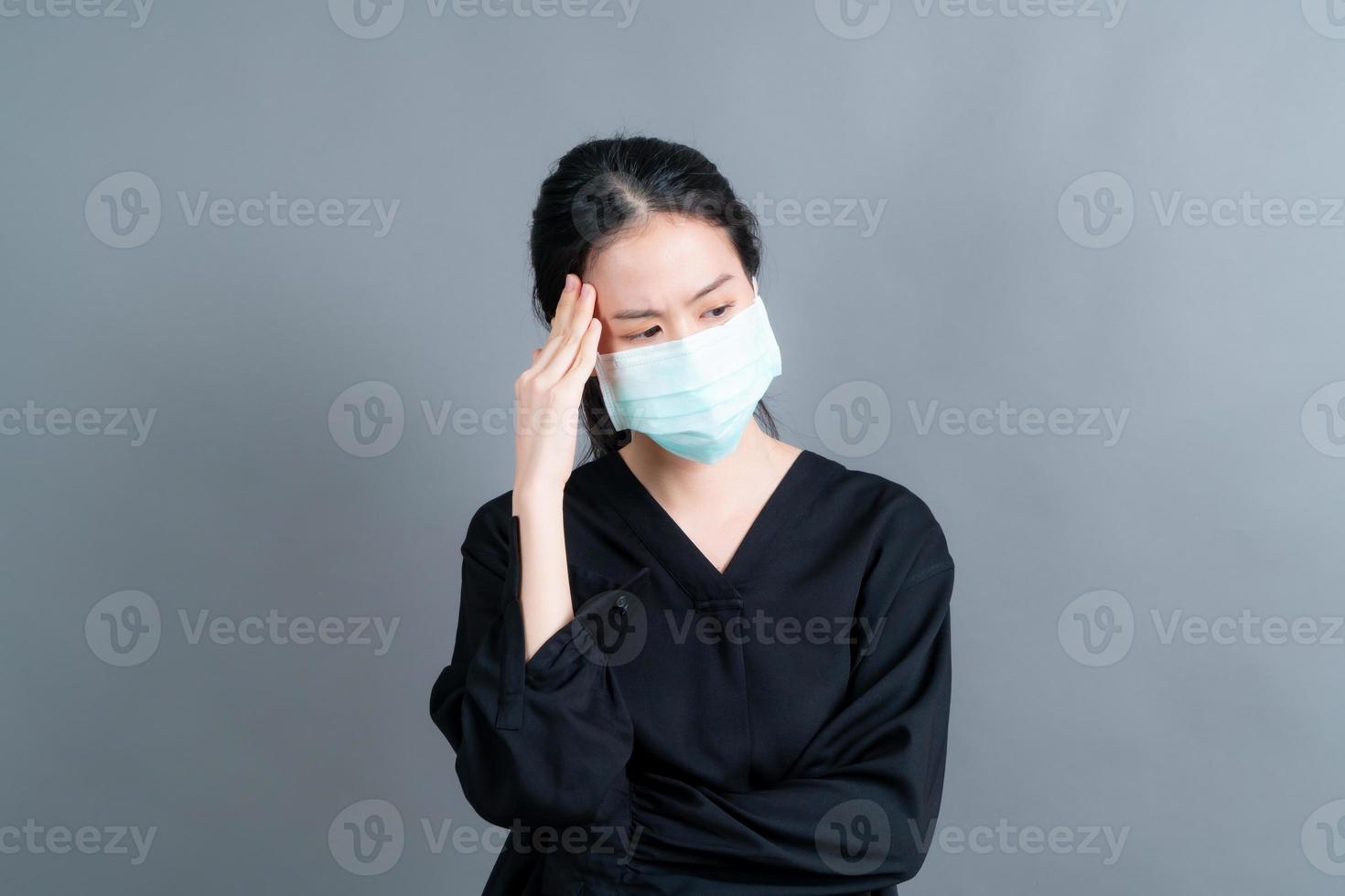 Asian woman wearing medical face mask protects filter dust pm2.5 anti-pollution, anti-smog, and COVID-19 photo