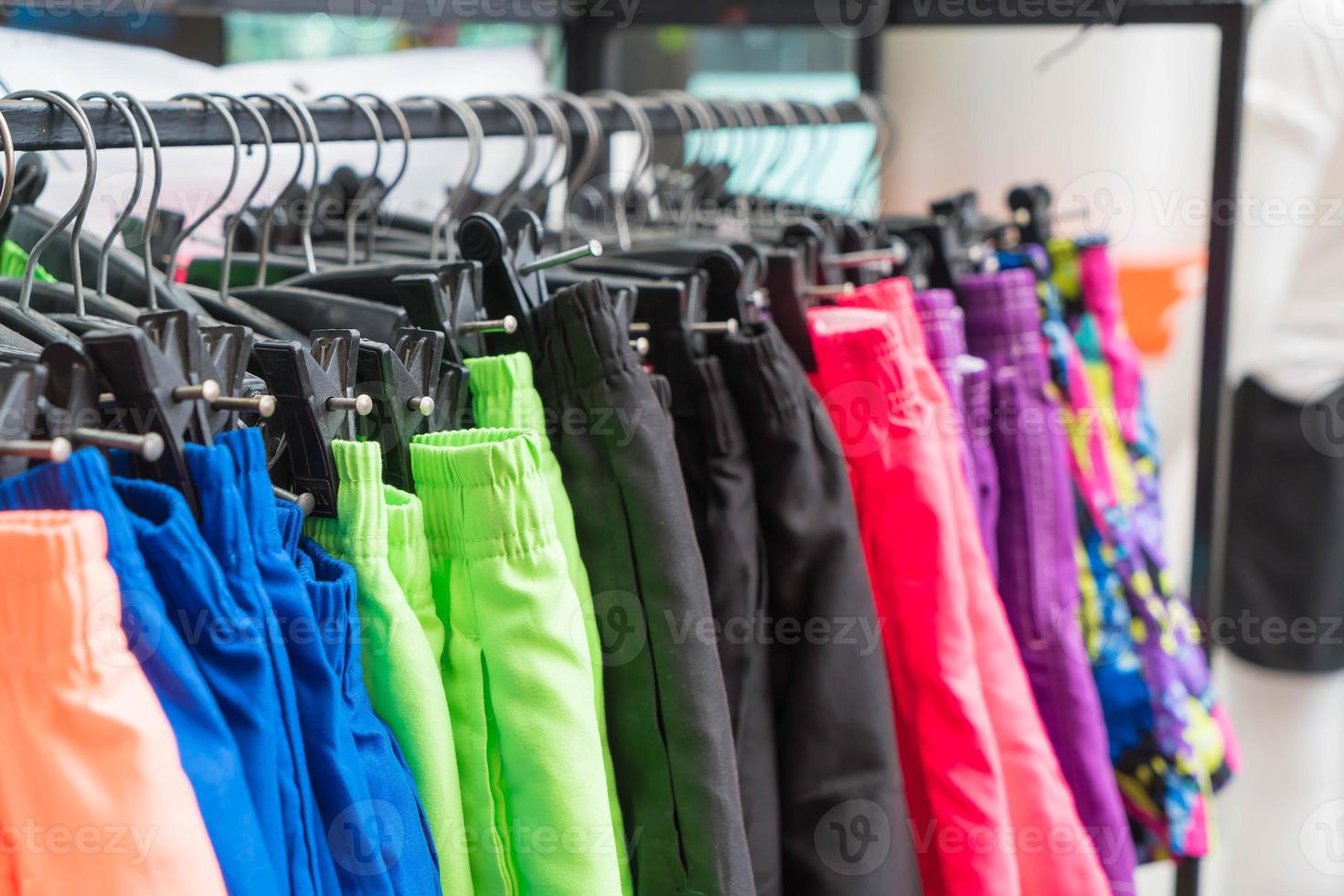 Clothes hang on shelf photo