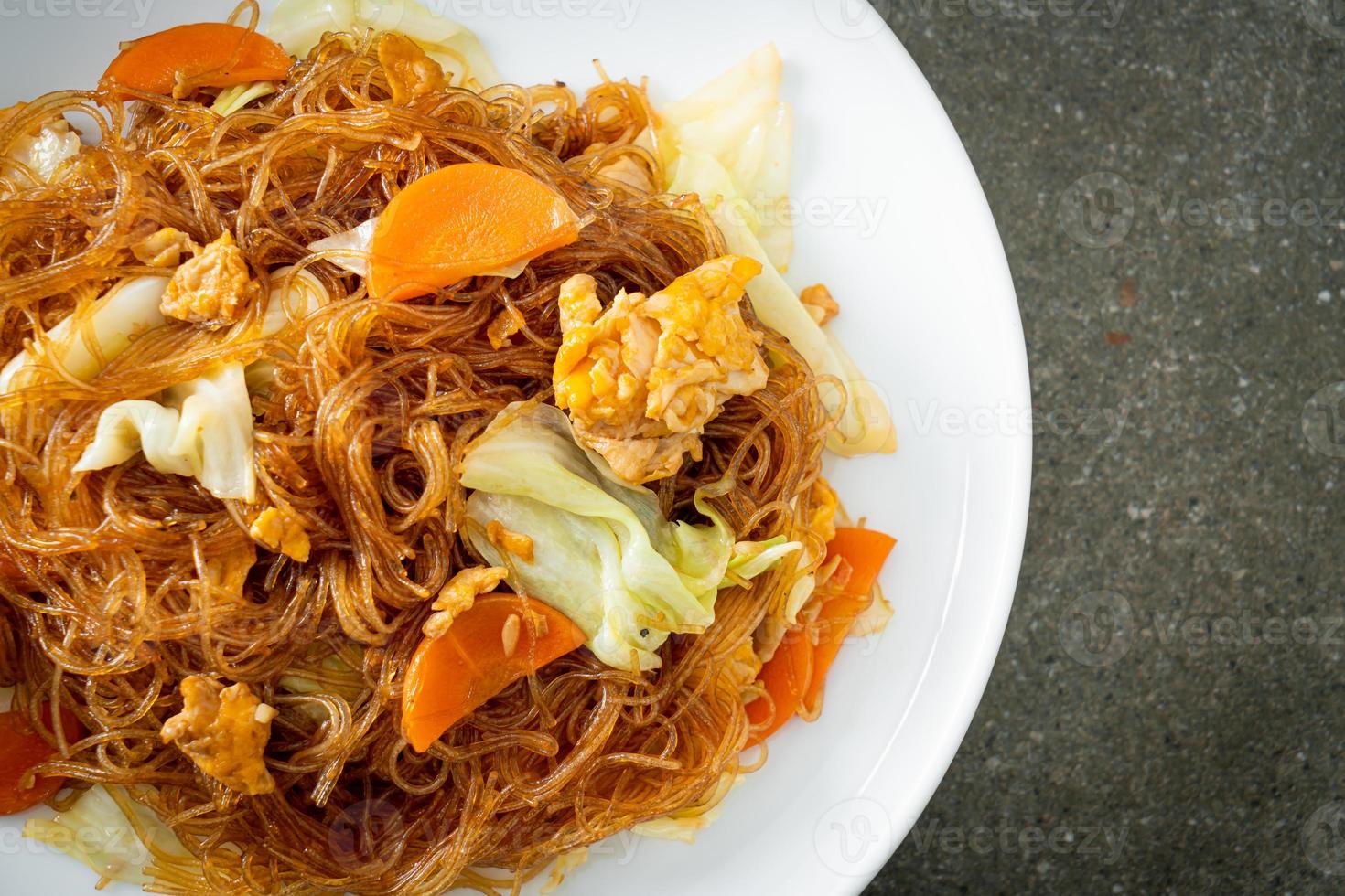 Stir-fried vermicelli with cabbage, carrots, and egg - vegan food style photo