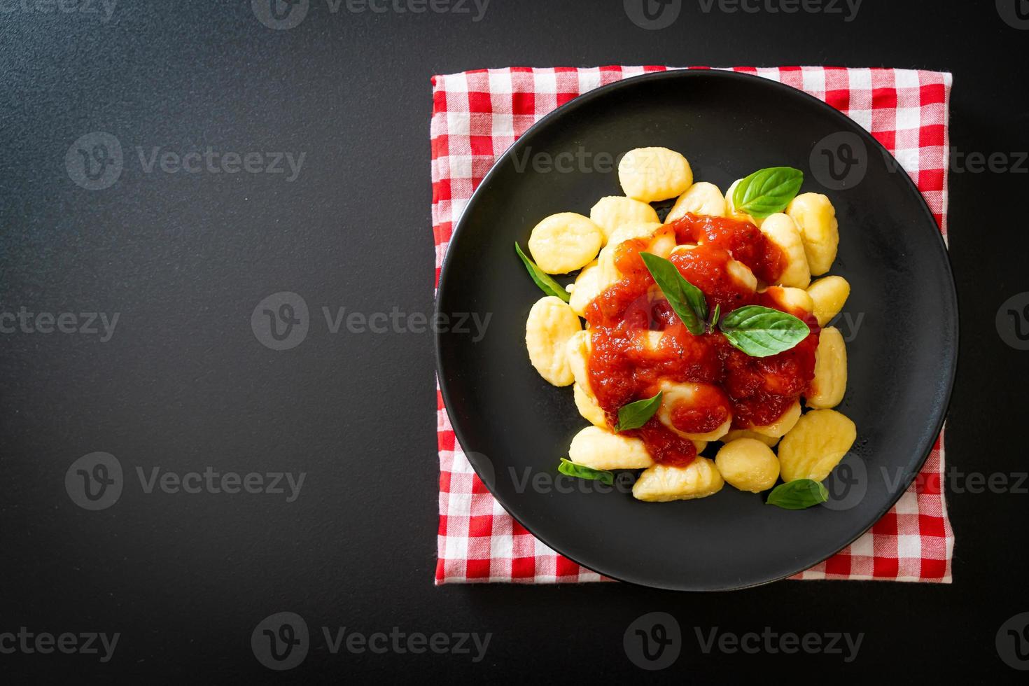 Gnocchi in tomato sauce with cheese - Italian food style photo