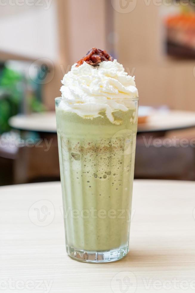 Matcha green tea latte blended with whipped cream and red bean in coffee shop cafe and restaurant photo