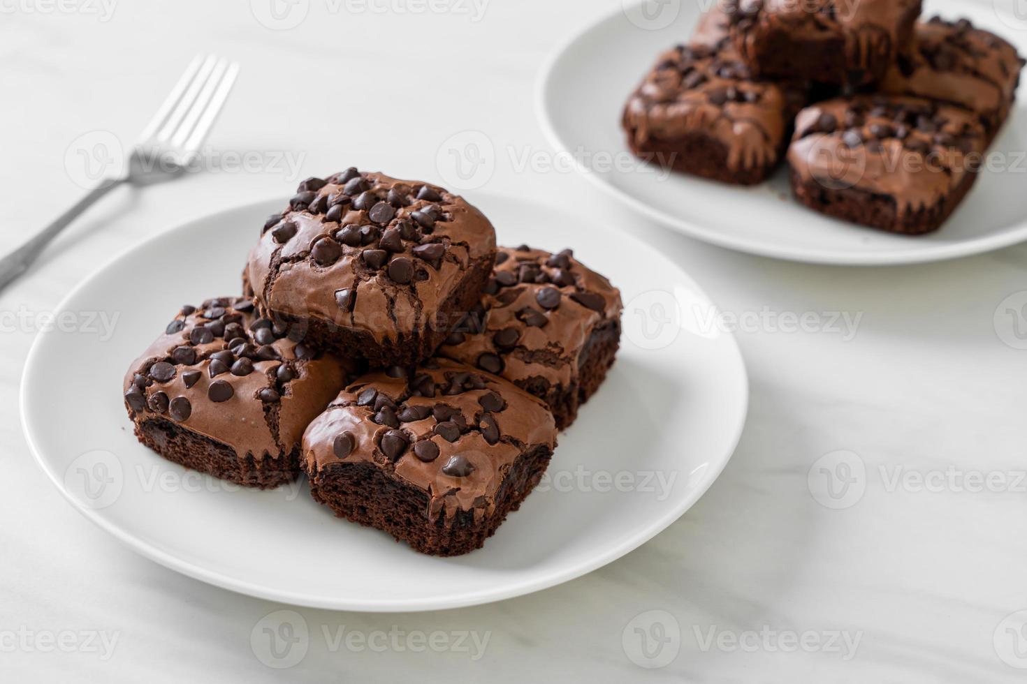 Dark chocolate brownies with chocolate chips on top photo