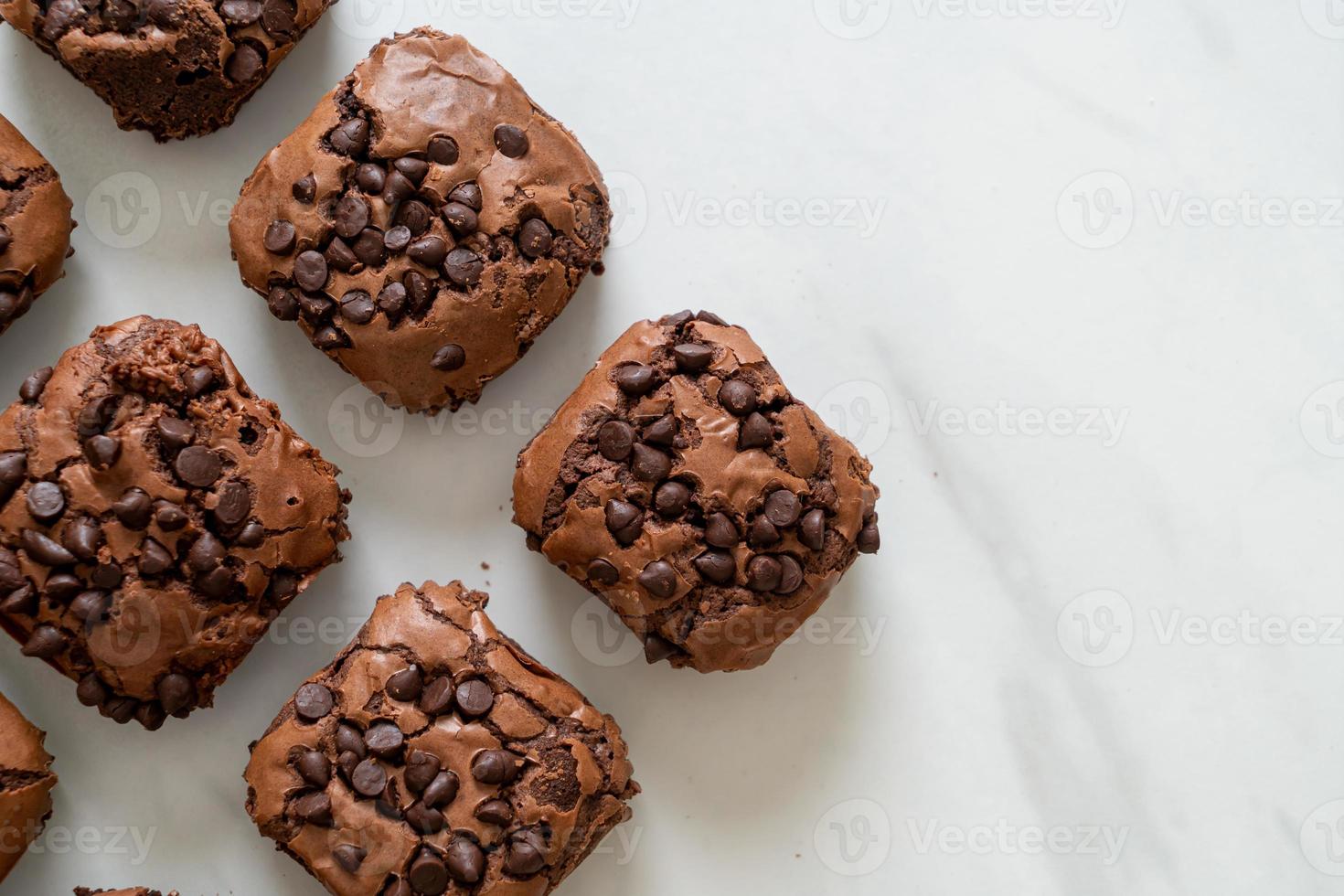 Dark chocolate brownies with chocolate chips on top photo