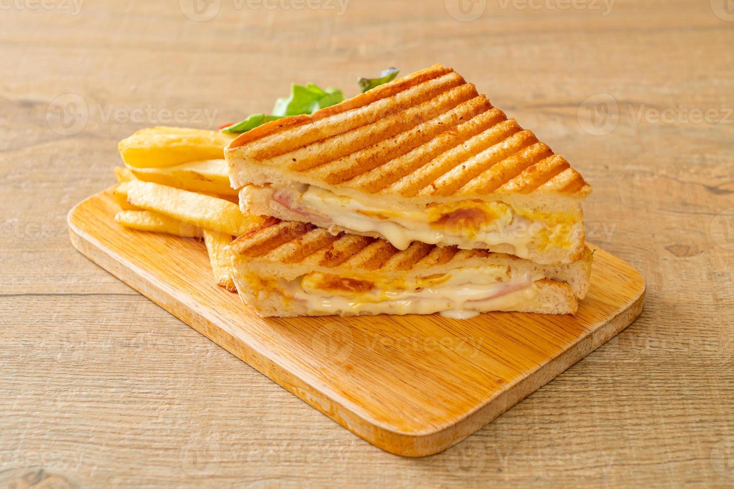 Ham cheese sandwich with egg and fries photo