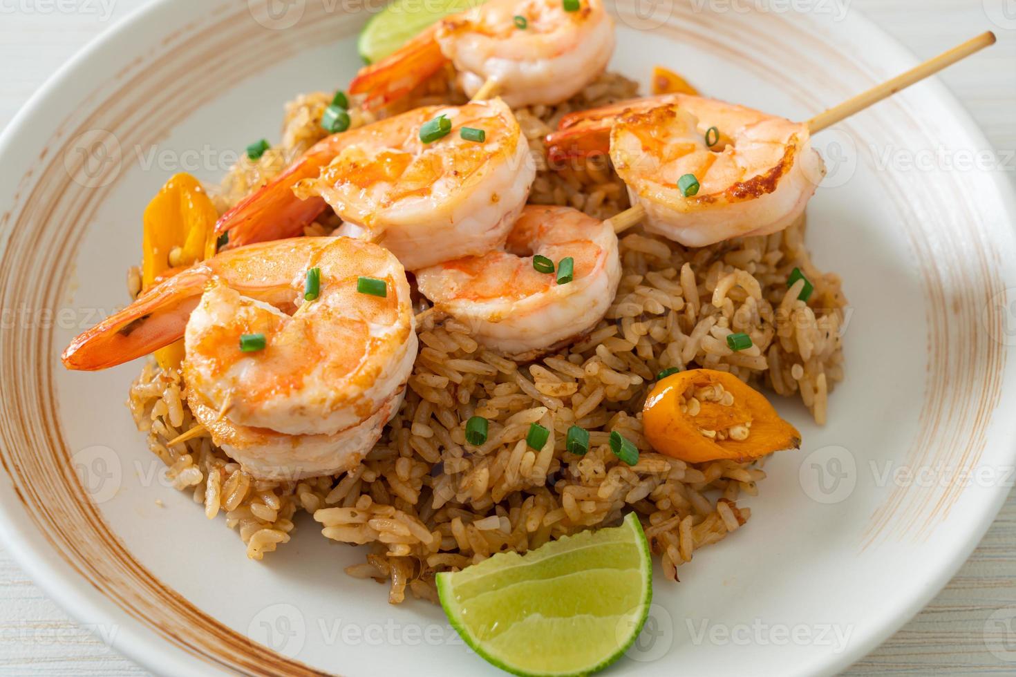 Fried rice with shrimps or prawns skewers photo