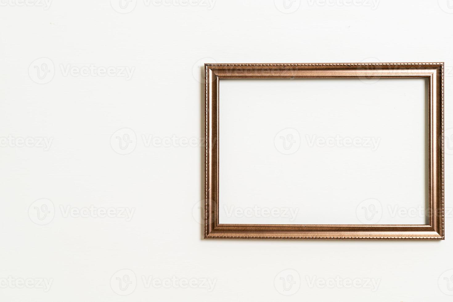 Empty picture frame on white wall background with copy space photo