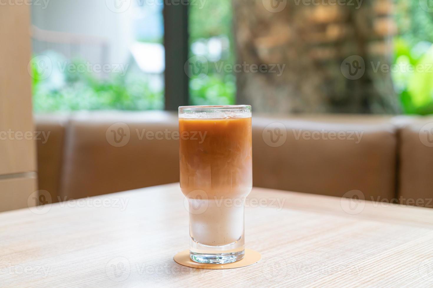 Iced latte coffee glass in coffee shop cafe and restaurant photo