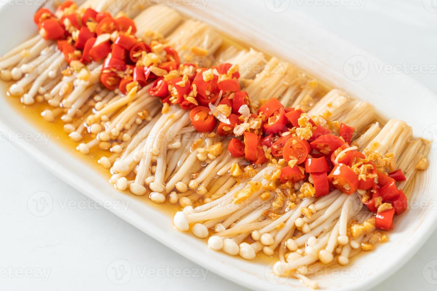 Homemade steamed golden needle mushroom or enokitake with soy sauce, chili, and garlic photo