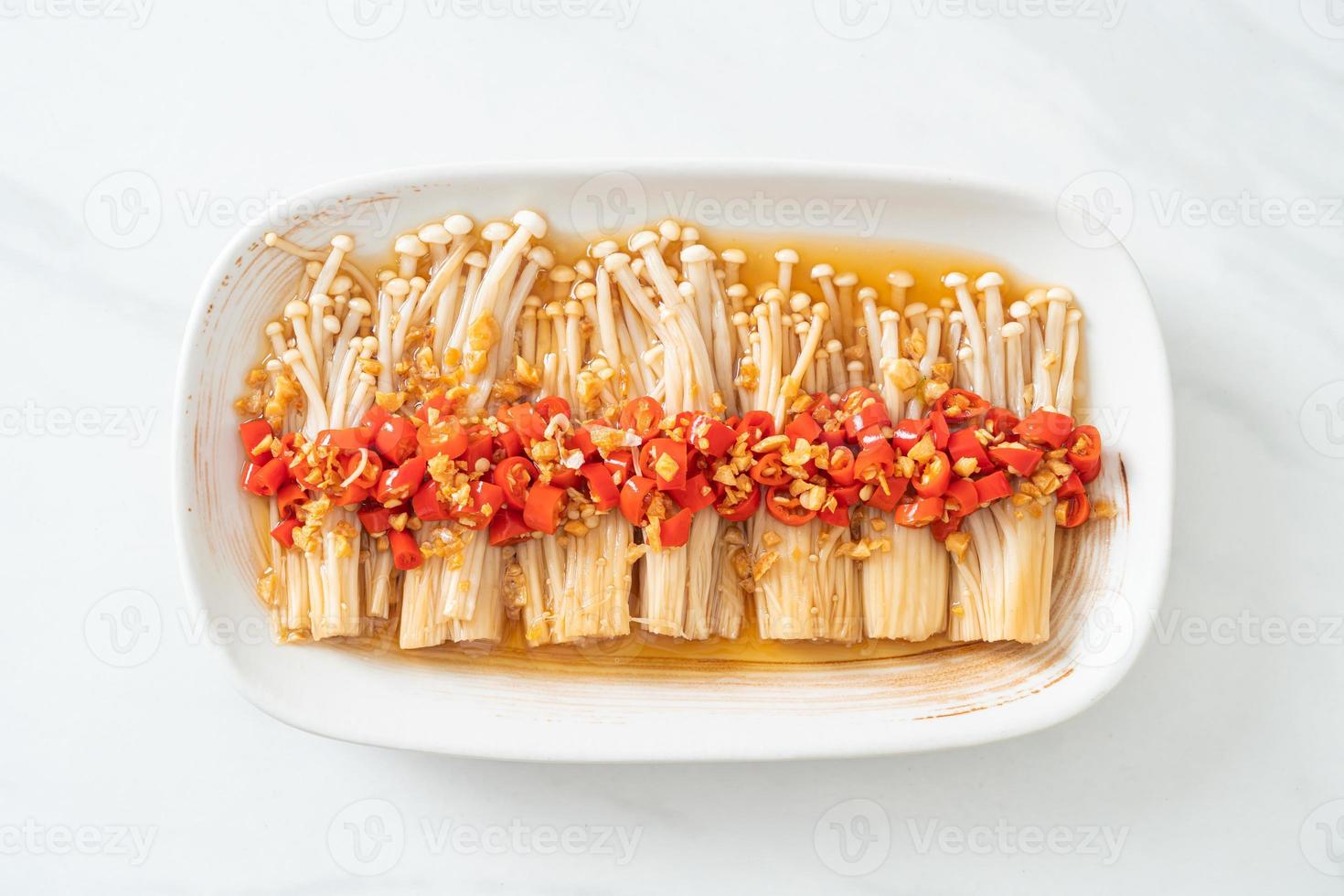 Homemade steamed golden needle mushroom or enokitake with soy sauce, chili, and garlic photo