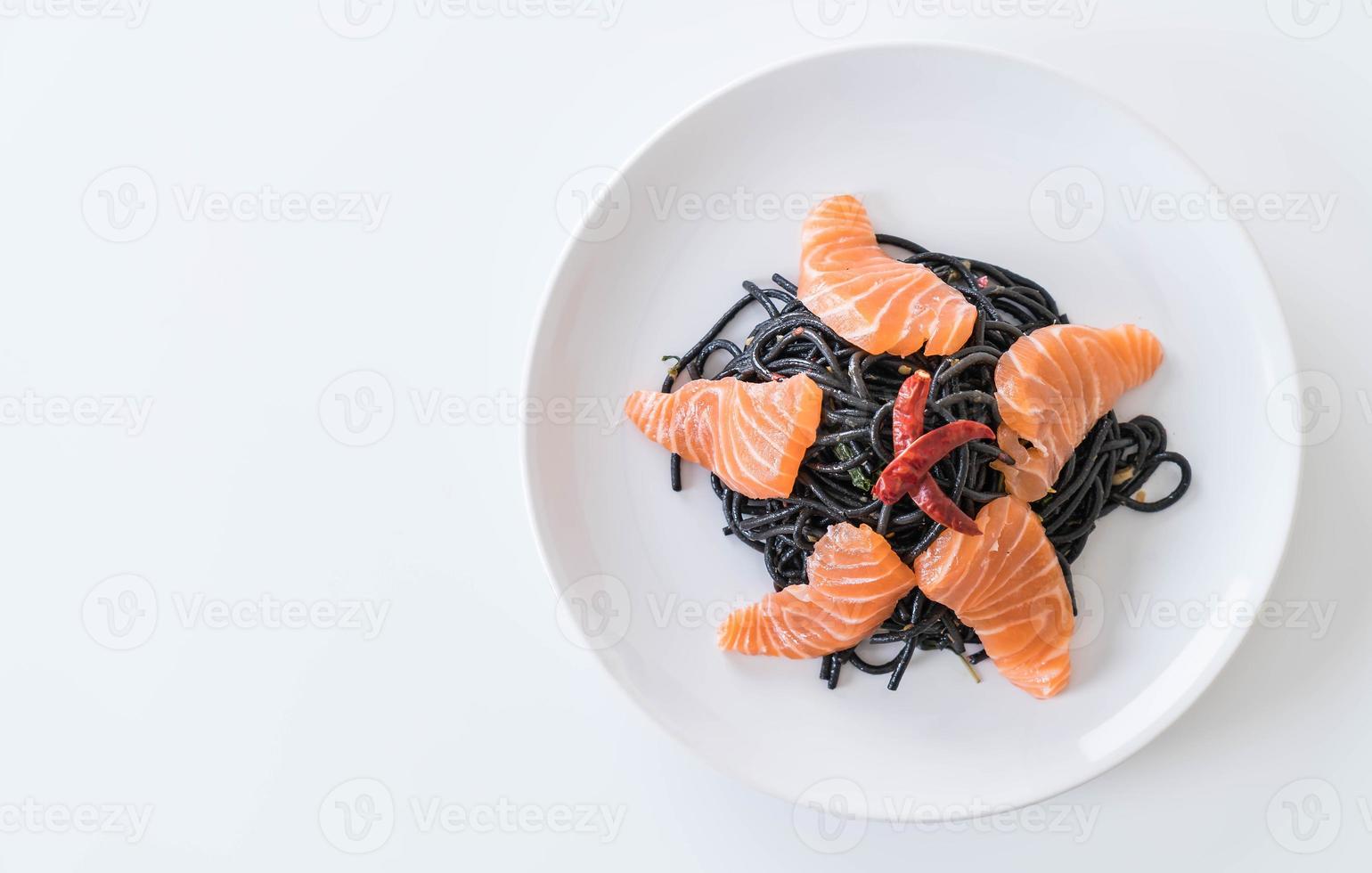 Spicy black spaghetti with salmon - fusion food style photo