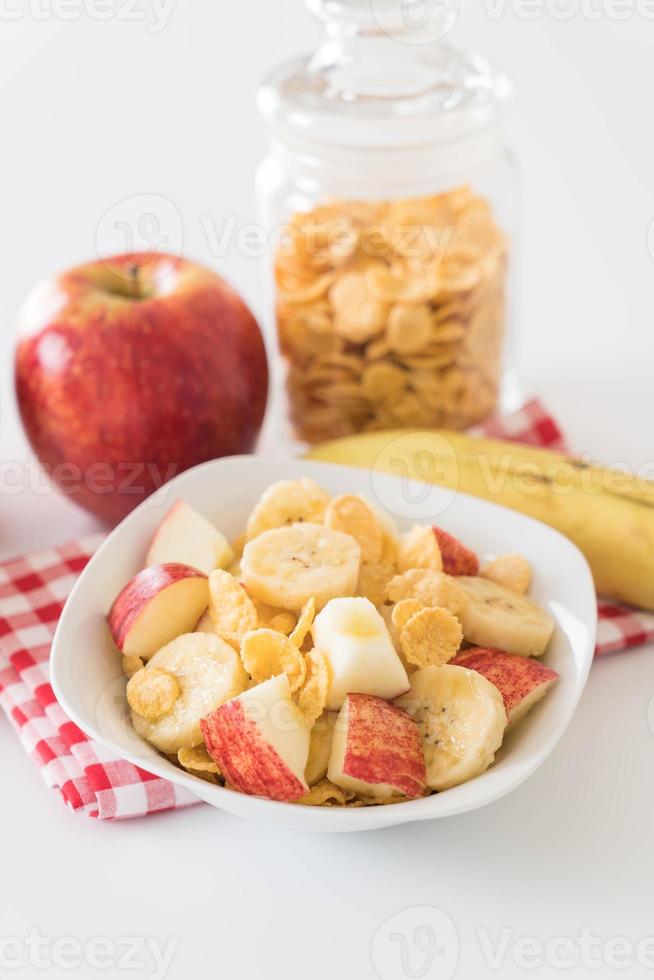 Milk, apple, banana, and cornflakes for breakfast photo