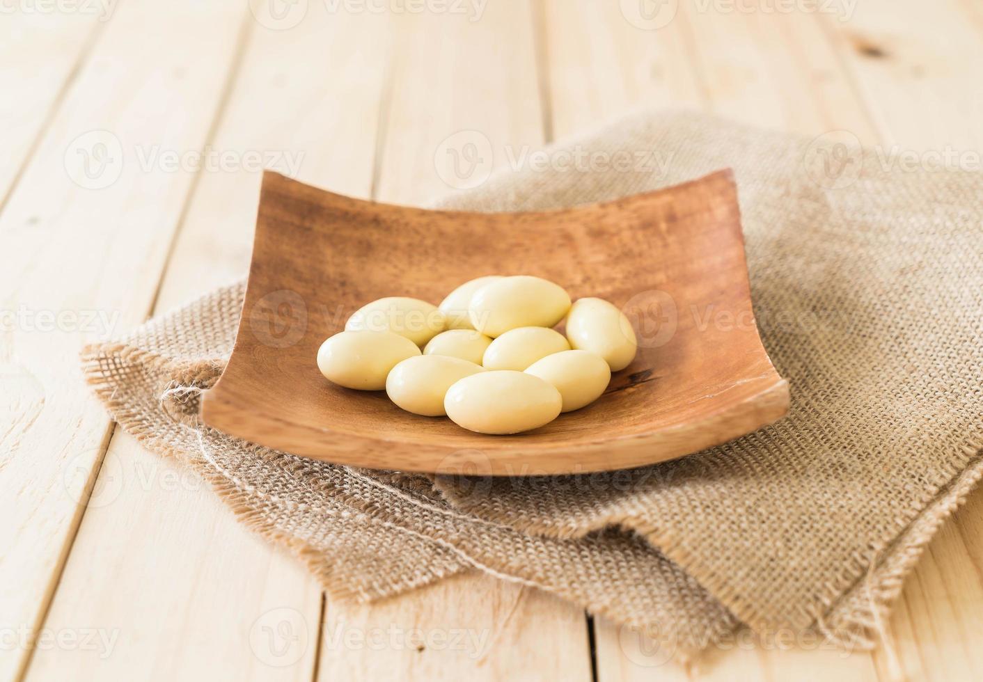 White chocolate ball on wood plate photo