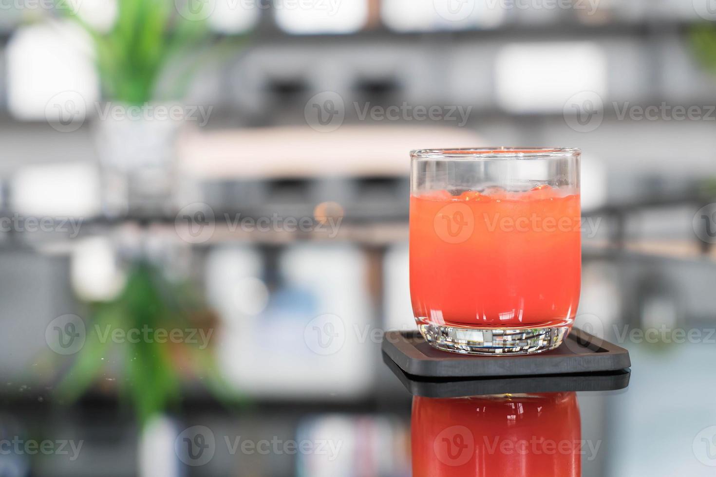 Glass of punch juice on table photo