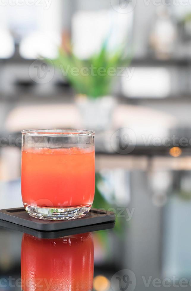 Glass of punch juice on table photo