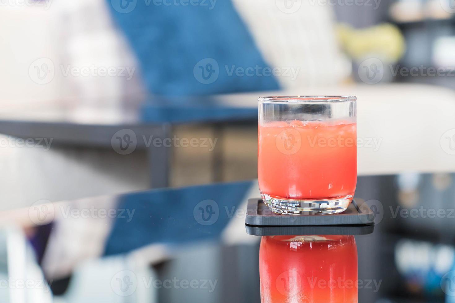 Glass of punch juice on table photo