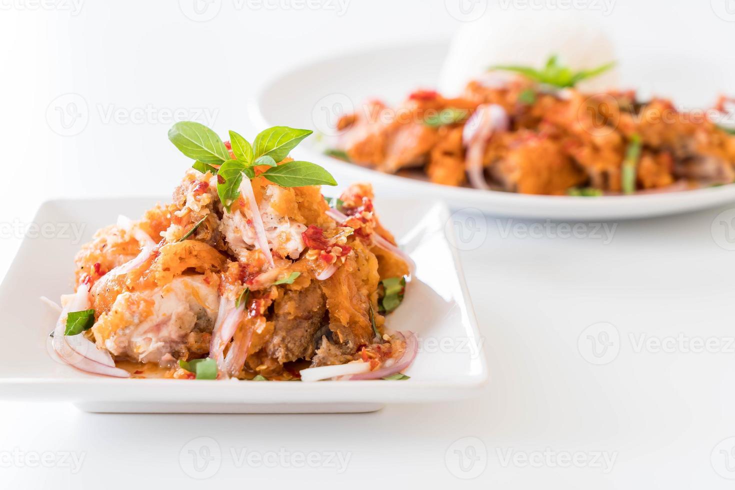 Spicy salad with fried chicken with rice photo