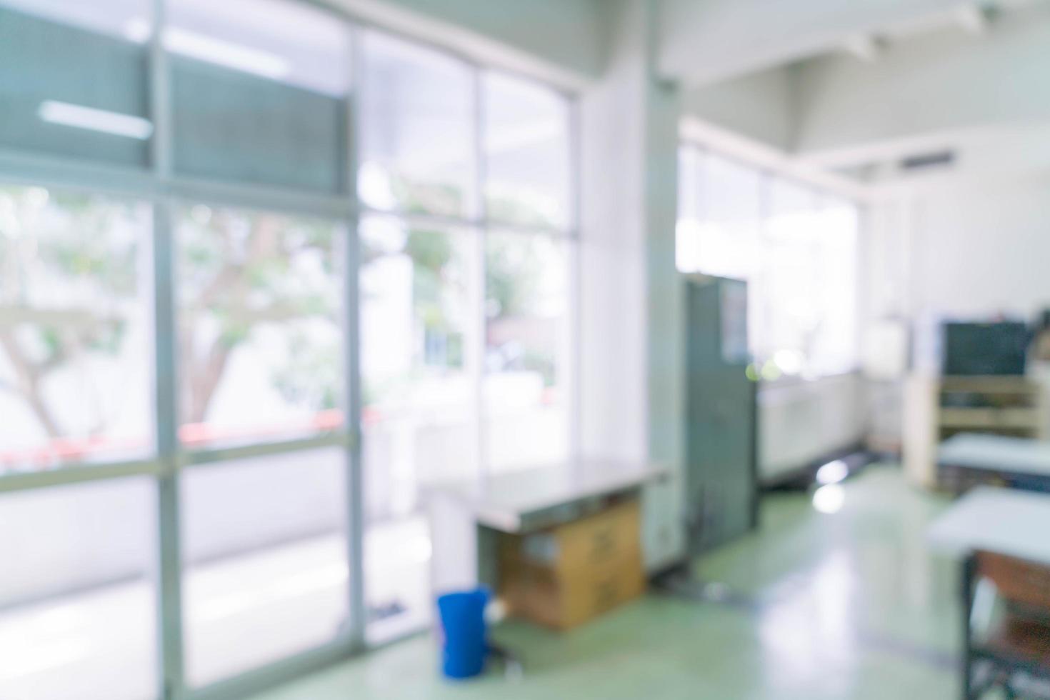 Blurred abstract background interior view looking out toward to empty office lobby and entrance doors and glass curtain wall with frame photo