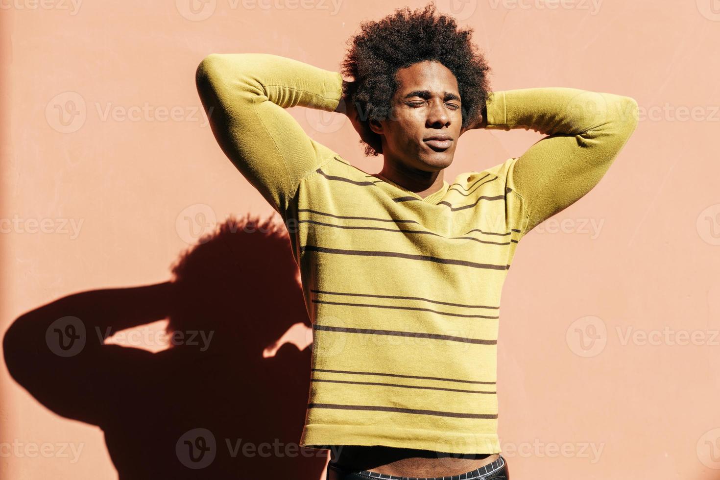 Cuban black man enjoying the andalusian sun with his eyes closed photo