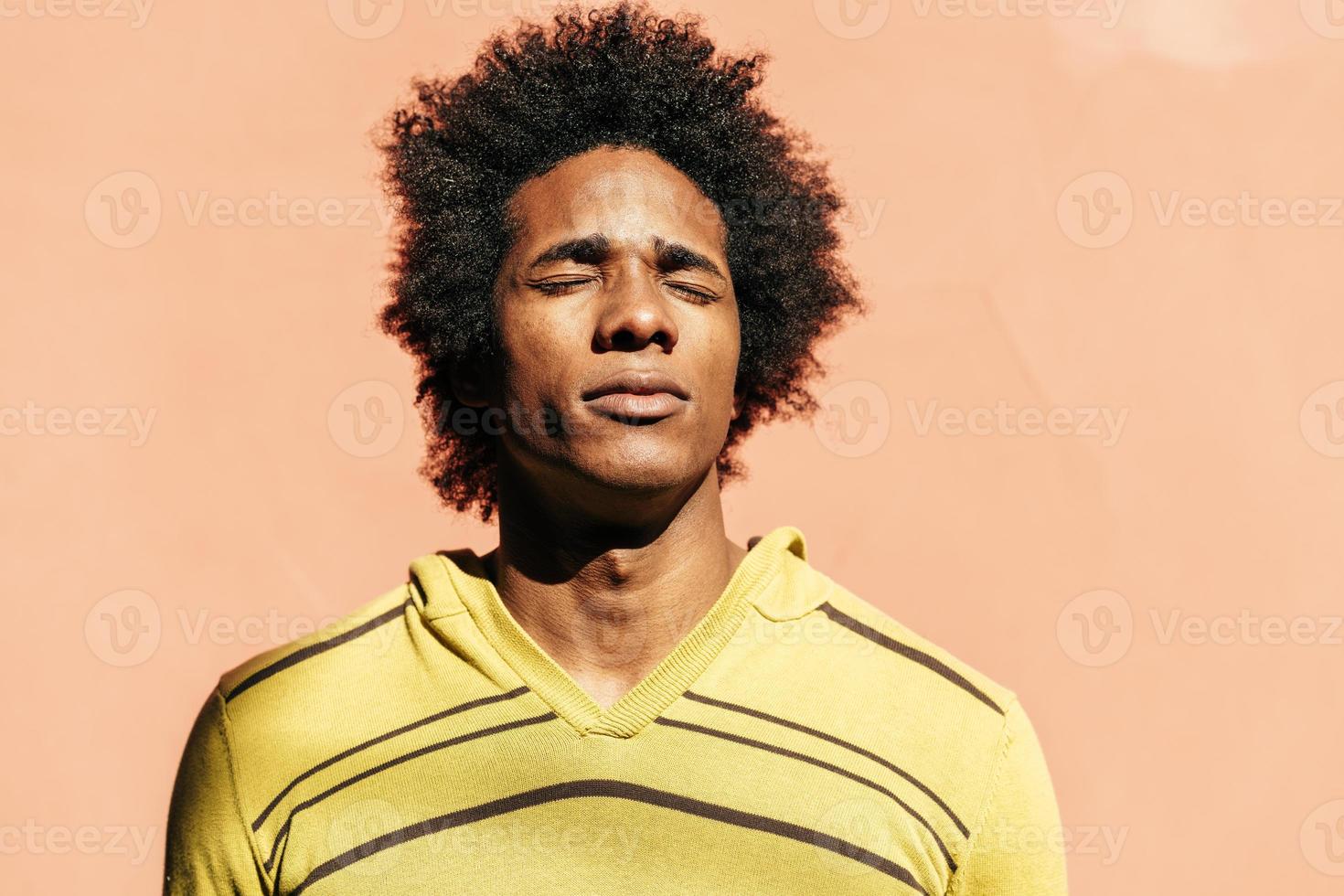 Cuban black man enjoying the andalusian sun with his eyes closed photo