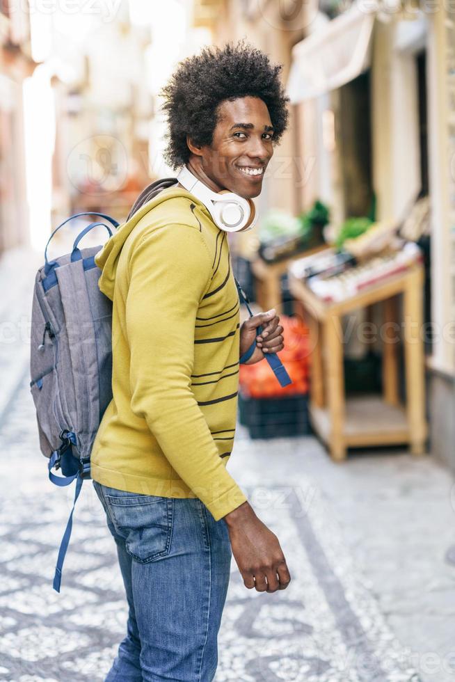 Black man with wireless headphones sightseeing in Granada photo