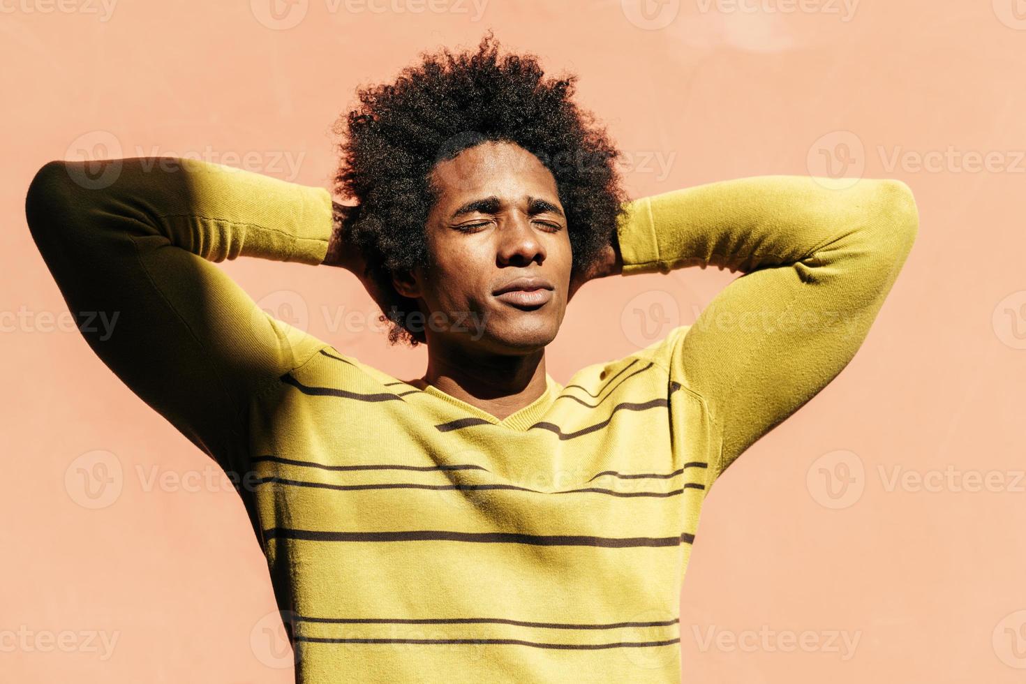 Cuban black man enjoying the andalusian sun with his eyes closed photo