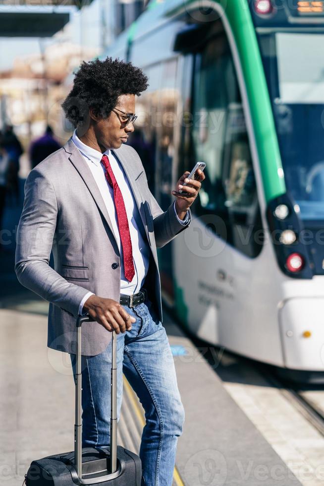 Black Businessman wearing suit waiting his train photo