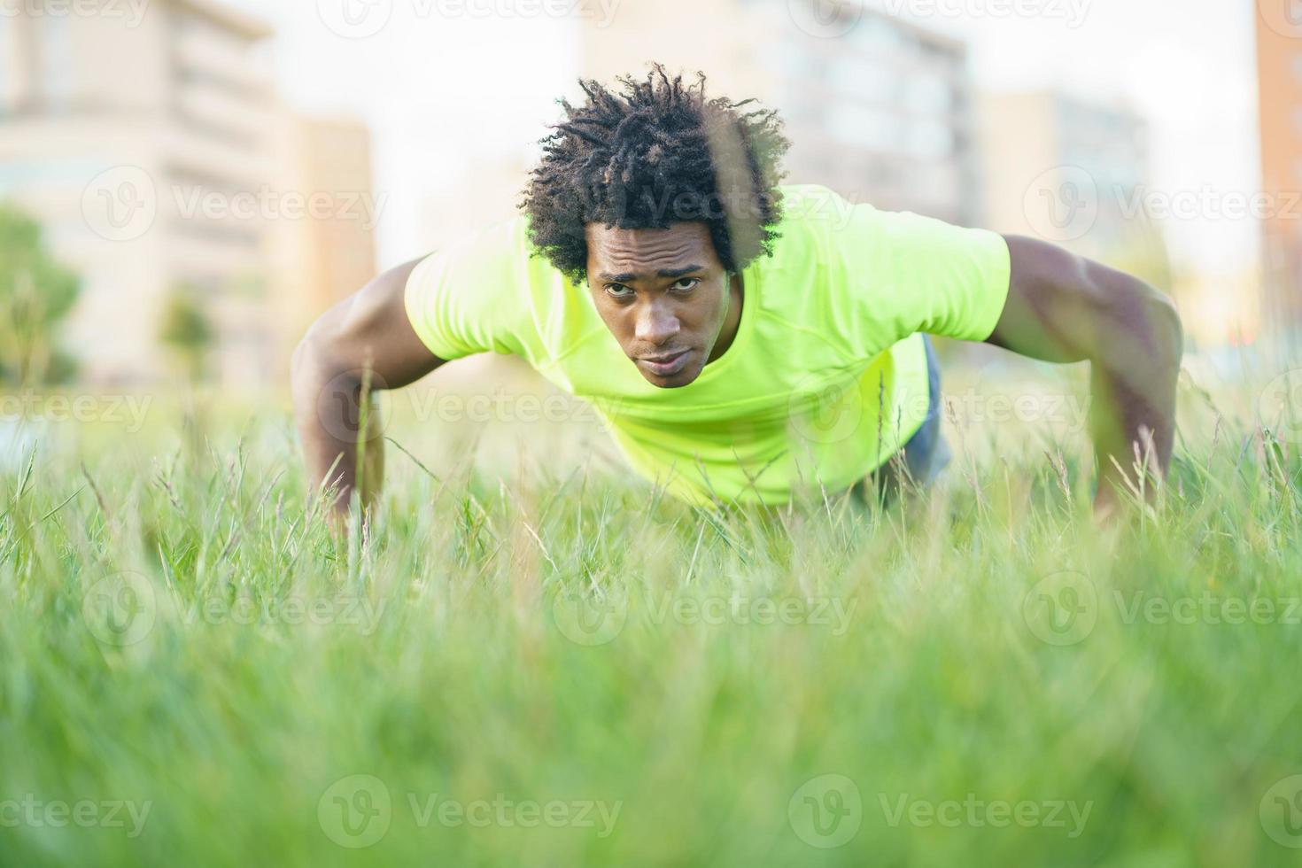 Black man doing push-ups photo