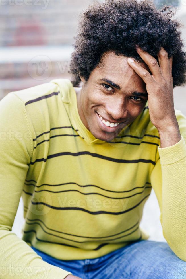 Cuban black tourist with afro hair sitting on the floor photo