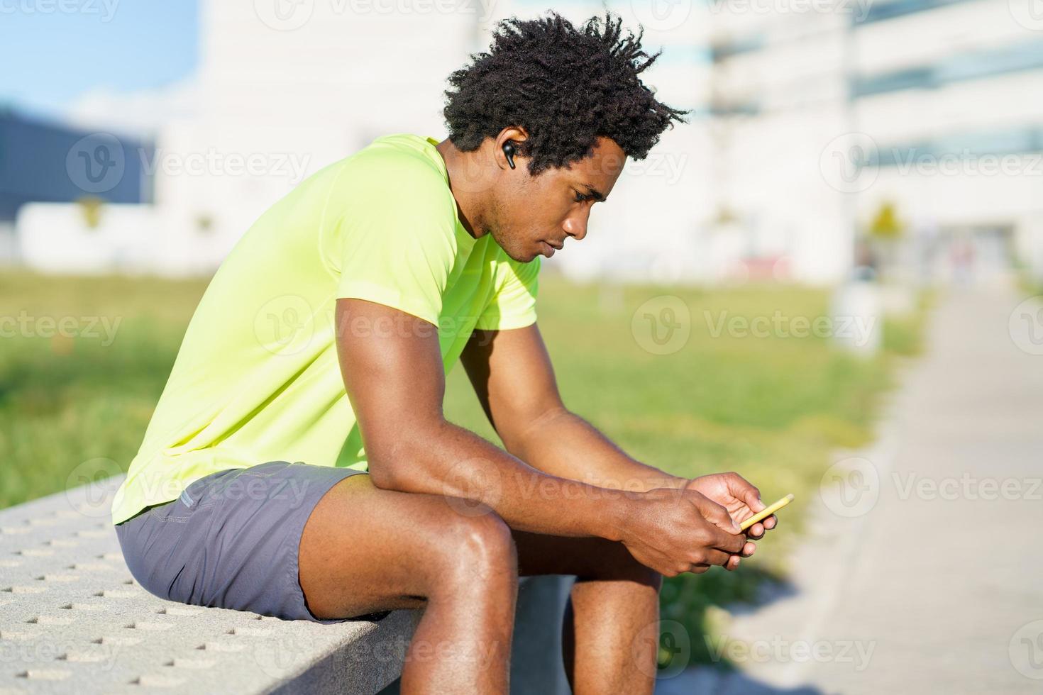 Black man consulting his smartphone photo