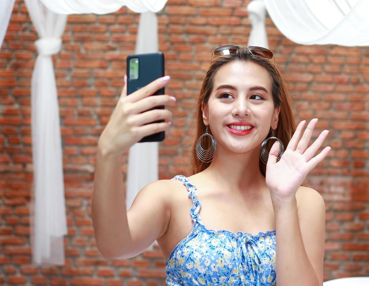 Asian woman happily take selfies at home on vacation photo