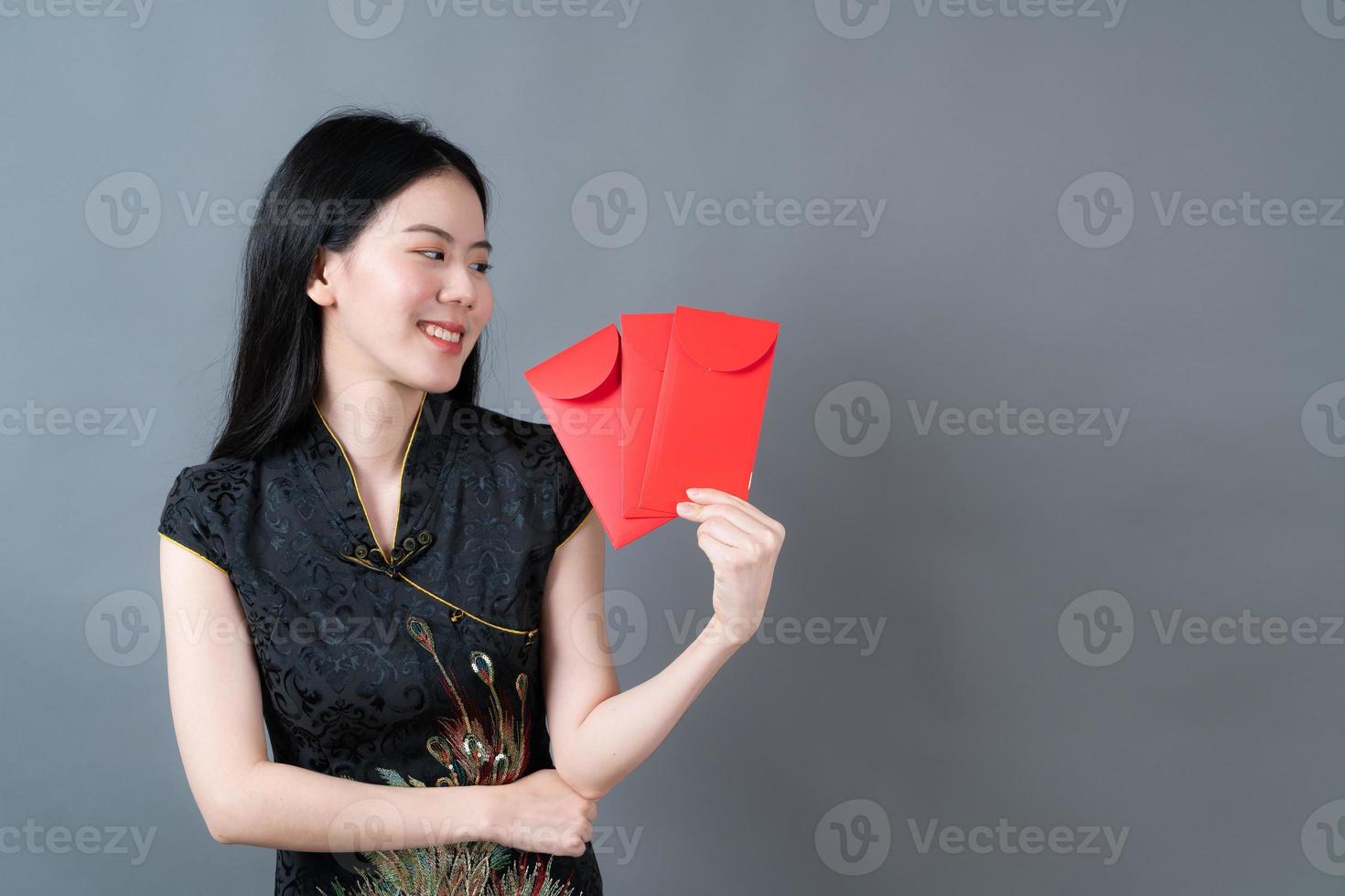 Asian woman wear Chinese traditional dress with red envelope or red packet photo